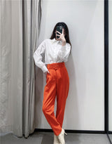 Pantaloni Stezzia portocalii conici accesorizati cu o curea