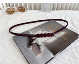 Curea subtire cu elemente decorative in mijloc